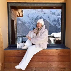 Chic beige faux shearling jacket for women with lapel collar in a snowy mountain setting