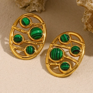 Macro shot of 18K gold plated oval earrings with green malachite texture and hollow design
