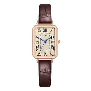 Close-up of square quartz watch featuring a champagne dial with blue hands and brown leather strap