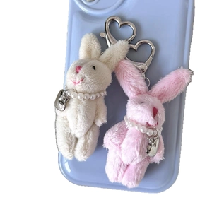 Plush white and pink bunny keychains with pearl necklaces and heart clasps