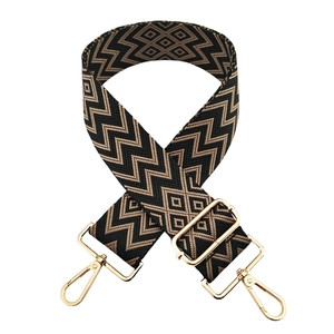 Detail of 5cm wide beige wave pattern bag strap with gold hardware and swivel hooks