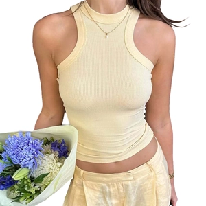 Detail of light yellow ribbed knit halter top showing slimming fit and premium texture