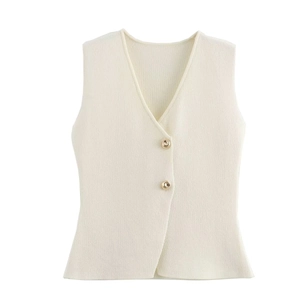 Detail of cream knit vest featuring a V-neckline and elegant gold button accents