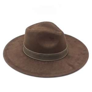 Detailed close-up of brown wide-brim suede fedora hat with elegant dark ribbon band