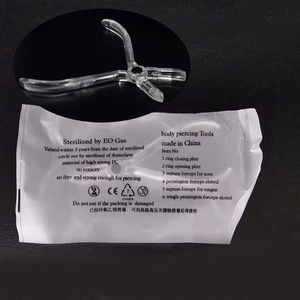 Detailed view of clear acrylic body piercing pliers in EO gas sterile packaging