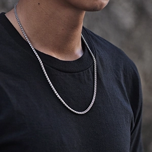 Sleek silver titanium steel cuban chain necklace worn by a male model for a modern look