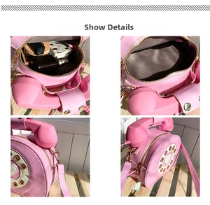 Detail view of pink telephone-shaped crossbody bag interior showing storage for cosmetics