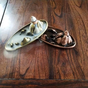 Zen style mountain backflow incense burner showing smoke flowing like a waterfall