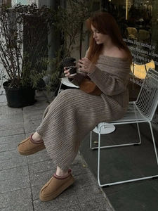 Detail of off-shoulder rib-knit maxi dress in taupe paired with stylish plush slippers