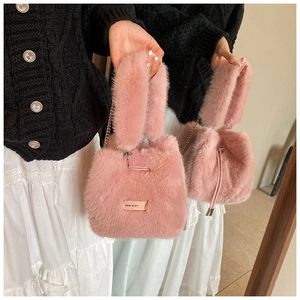 Detail of pink plush bucket bag with golden chain strap and Love every day tag