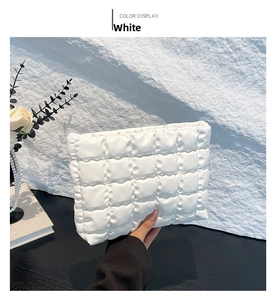 Détail du sac matelassé blanc montrant la texture en similicuir et les surpiqûres carrées