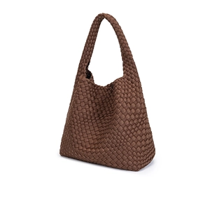 Detail shot of the brown woven texture and premium craftsmanship on a waterproof tote bag