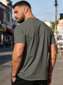 Close-up of high-quality grey cotton t-shirt fabric and seam detail in street light