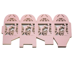 Flat lay of pink laser-cut wedding favor box showing bride and groom silhouette with thank you text