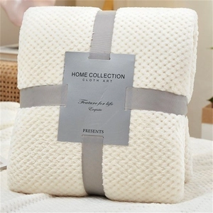 Creamy white waffle weave flannel blanket with a decorative gray ribbon packaging bow