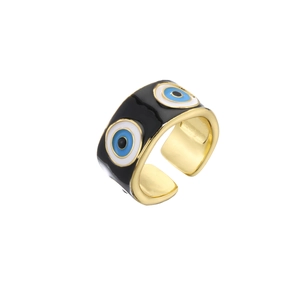 Detail of adjustable gold ring with black enamel and blue evil eye patterns