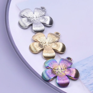 Detailed view of flower-shaped pendants in silver, gold and rainbow finishes