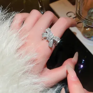 Sparkling zircon bow open ring for women crafted in silver finish with pavé stones