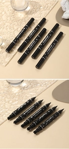 Close-up of dual-ended liquid eyeliner pens with star and heart shape stamp tips