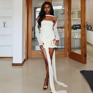 White mini dress featuring off-shoulder mesh sleeves and long fringe tassel detail