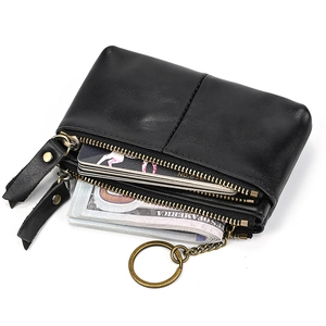 Detail view of black leather coin purse with double zippers, key ring and card slots