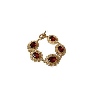 Vintage gold bracelet with red oval gemstones and small white pearls and T-bar clasp