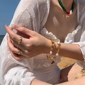 18k gold plated chain bracelet with freshwater pearls and wavy rings on model