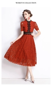 Close-up of a red lace embroidered dress with mid-sleeves and black lace waist detailing