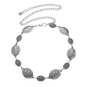 Detailed close-up of bohemian metal waist chain with vintage embossed floral textures