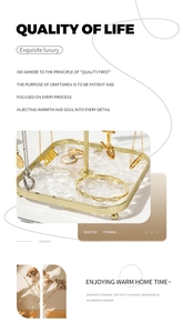 Detail view of gold jewelry stand with acrylic base showing necklaces and rings storage