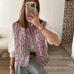 Detail of floral print quilted vest with delicate pink flower patterns and round neck