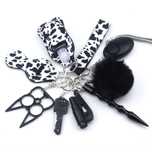 10-piece safety keychain set for women featuring cow print wristlet and various tools