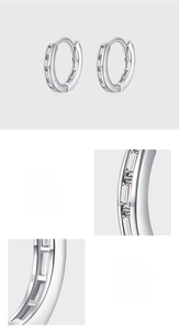 Macro detail of S925 sterling silver hoop earrings with bezel set baguette zirconias