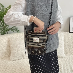 Detail of plush crossbody bag showing the woven geometric texture and sozakka logo label