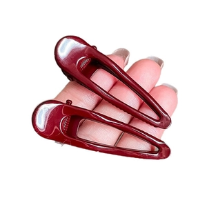 Pair of deep red geometric pleated hair clips in minimalist water-drop hollow design