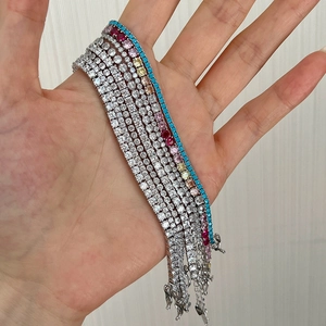 Close-up showing a variety of silver S925 tennis bracelets with colorful zircon stones