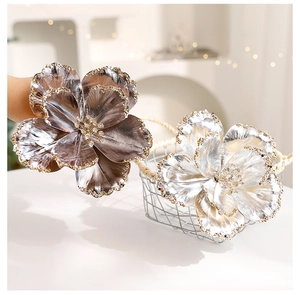Close-up of artificial glitter Christmas flowers in champagne gold and silver metallic finish