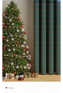 Detail of green plaid Christmas curtain with red stripes and textured fabric weave