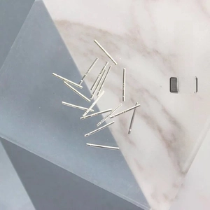Close-up of S925 sterling silver anti-allergy ear care sticks on a marble surface