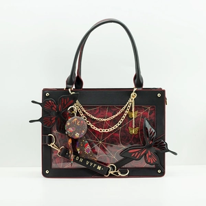 Detail view of gothic butterfly tote bag featuring transparent window and red rose pattern