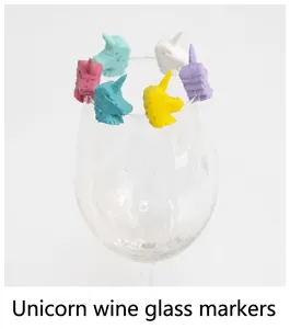 Close-up of colorful unicorn silicone wine glass markers on a clear wine glass rim