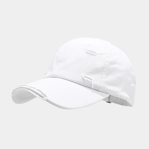 Close-up of distressed details and frayed edges on a white cotton baseball cap