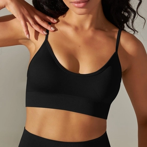 Detail of black seamless ribbed knit sports bra showing fine texture and thin straps