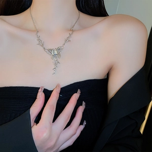 Silver butterfly thorn tassel necklace worn by a model to show elegant collarbone style