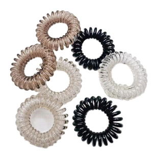 Set of 7 spiral hair ties in black, brown, and transparent colors on white background