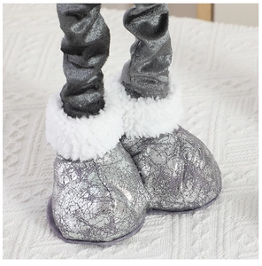 Close-up of silver cracked texture doll boots with white faux fur trim and knit background