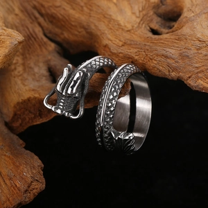 Detailed close-up of a vintage steel dragon ring showing intricate scale textures