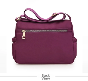 Detail view of large capacity purple oxford shoulder bag with back zipper pocket