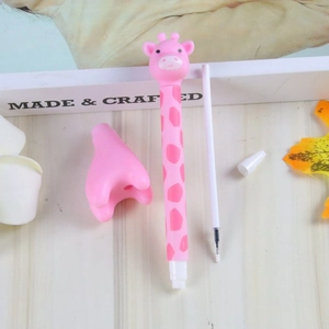 Pink giraffe silicone gel pen with extra ink refill on a minimalist wooden desk background