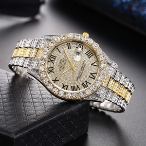 Macro shot of gold-silver tone watch with full rhinestones and Roman numeral dial